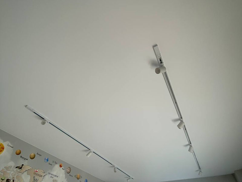 Накладная белая трековая система и белые светильники на натяжном потолке