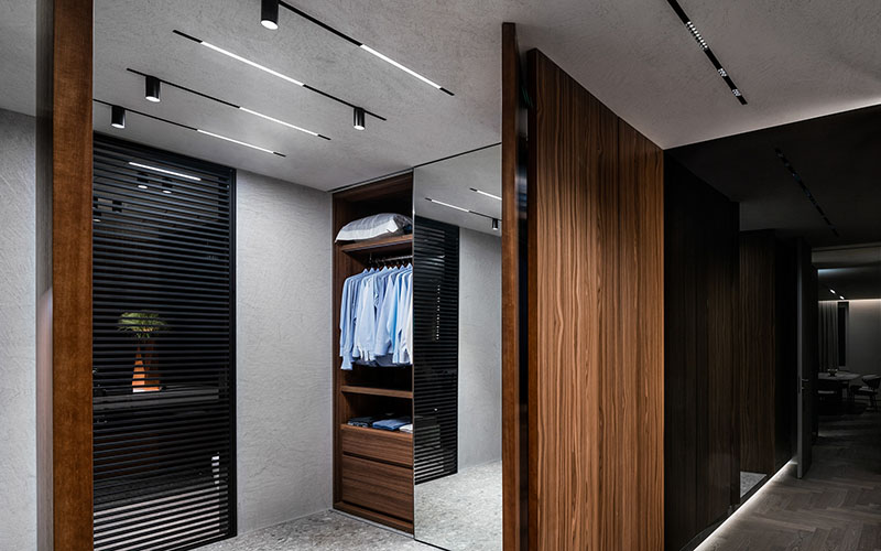 встроенная профильная трековая система со светящимися линиями в белый матовый натяжной потолок в интерьере узкой гардеробной, Гродно